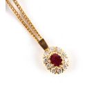 Property of a lady - an unmarked yellow gold (tests high carat) ruby & diamond pendant, the oval