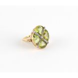 An unusual Continental unmarked 18ct yellow gold peridot & diamond ring, the quatrefoil setting with