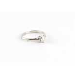 A platinum diamond single stone ring, the round brilliant cut diamond weighing approximately 0.52