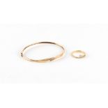 Property of a lady - a 10K yellow gold bangle, set with three small diamonds, approximately 4.6