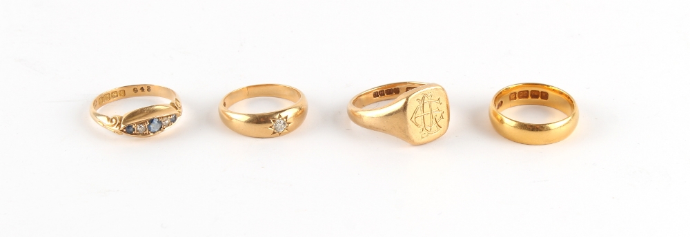 Property of a lady - a group of four yellow gold rings comprising an 18ct gold signet ring, size