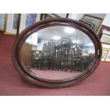 An Early XX Century Oval Wall Mirror, with egg and dart decoration, bevelled mirror.