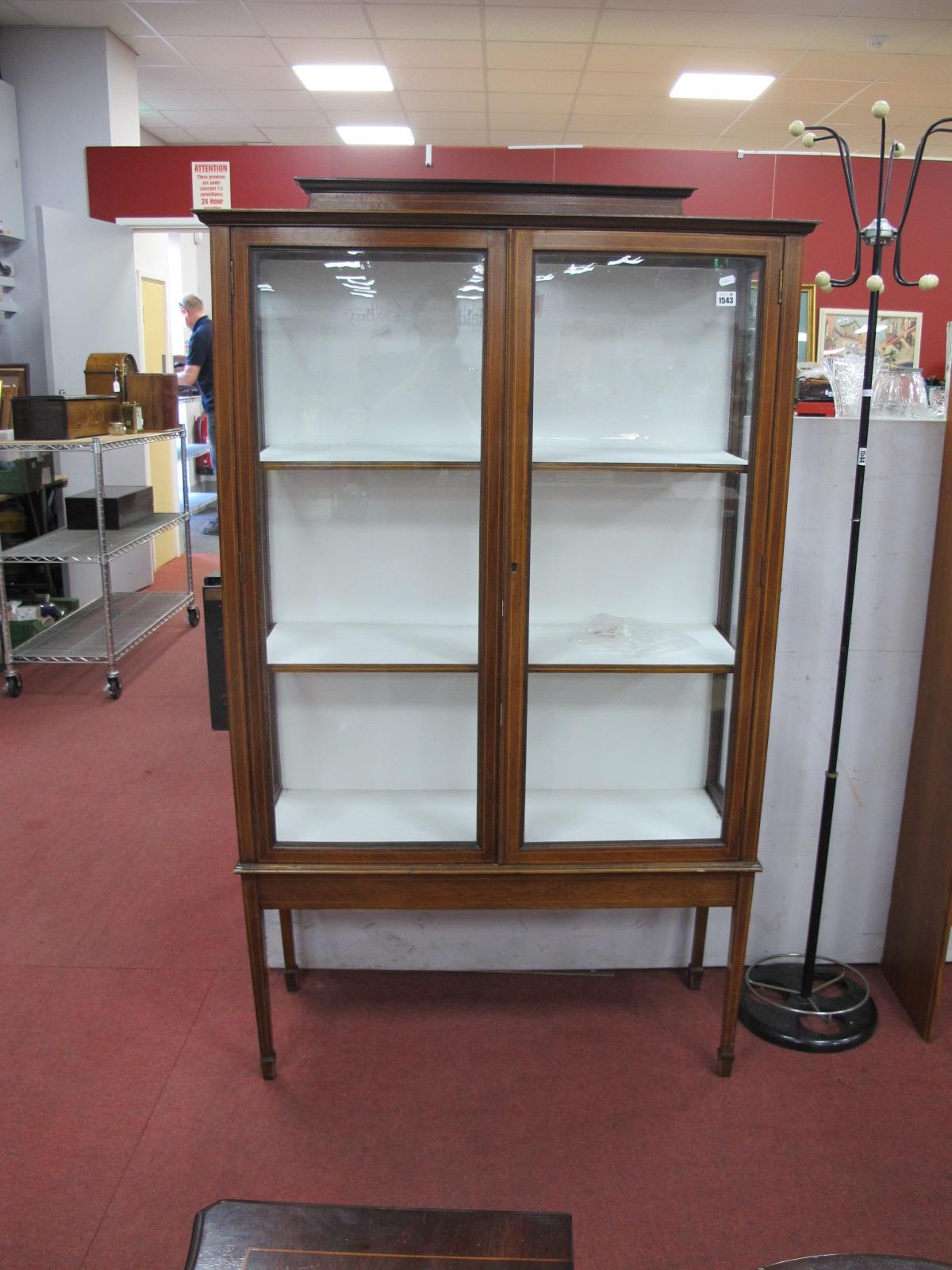 An Edwardian Inlaid Mahogany Display Cabinet, with shaped low back, twin glazed doors, tapering legs