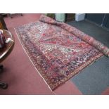 A Persian Style Wool Carpet, with red ground central lozenge decoration (slightly faded).