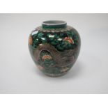 A Chinese Porcelain Ginger Jar, featuring sinuous Dragons amongst foliage, on black ground, six