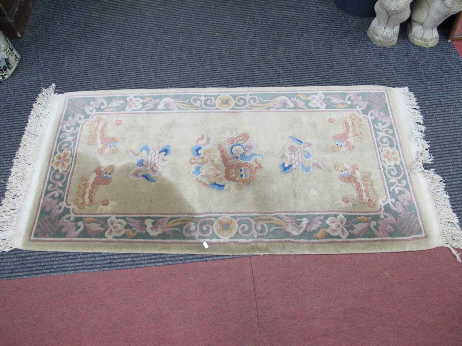 A Chinese Wool Tasseled Rug, featuring dragons and birds, on mustard ground, 158 x 78cm.