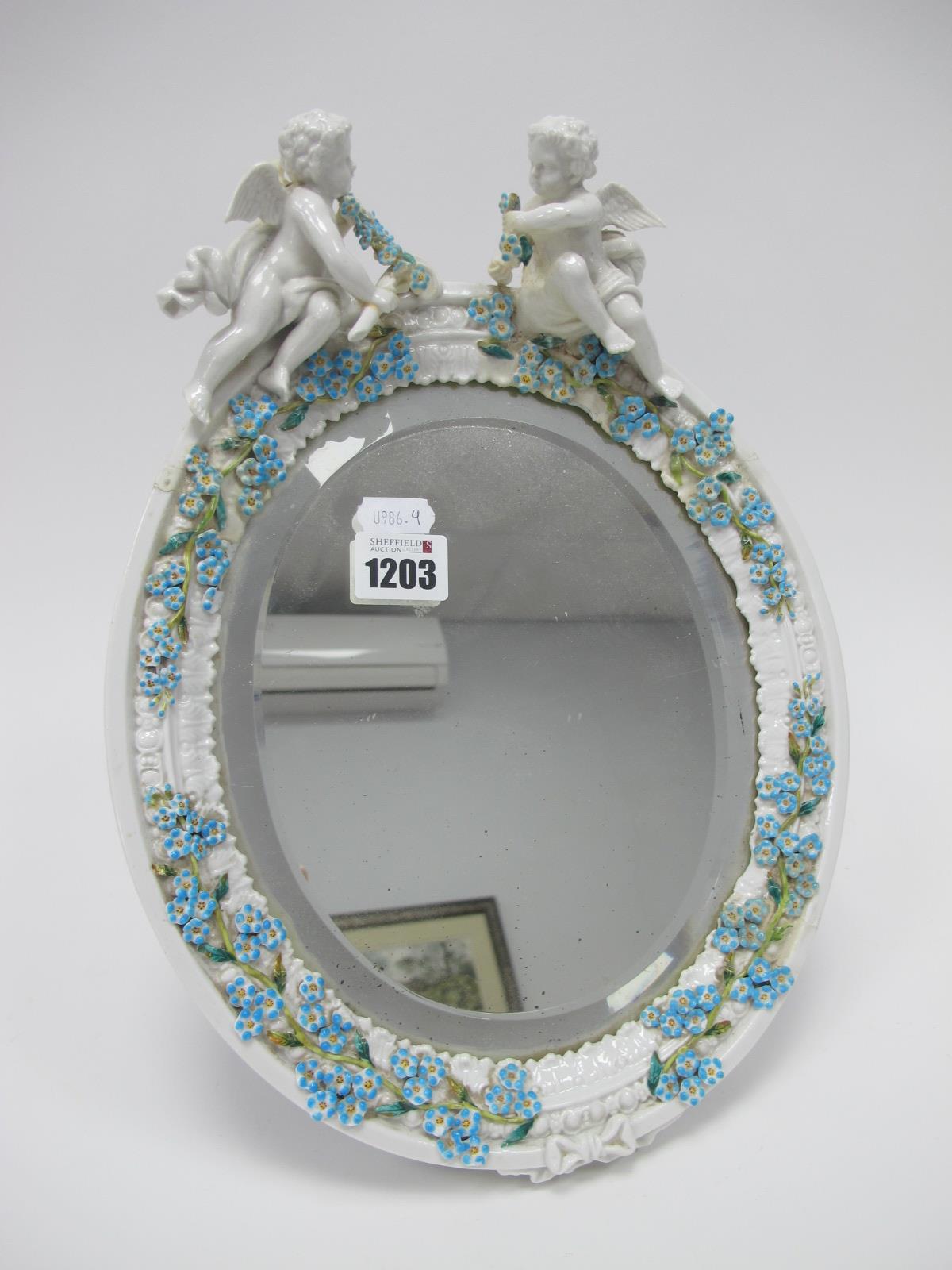 An Early XX Century Continental Pottery Dressing Table Mirror, with cherubs and floral decoration.