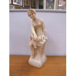 Alabaster Figure of a 1920's Lady, seated upon plinth (her right lower leg absent) 41cm high.