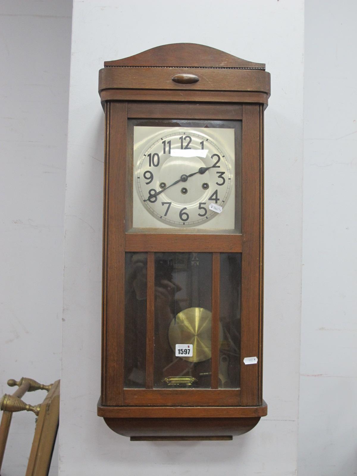 A 1940's Oak Cased Wall Clock, with a silvered dial, Arabic numbers, glazed door.