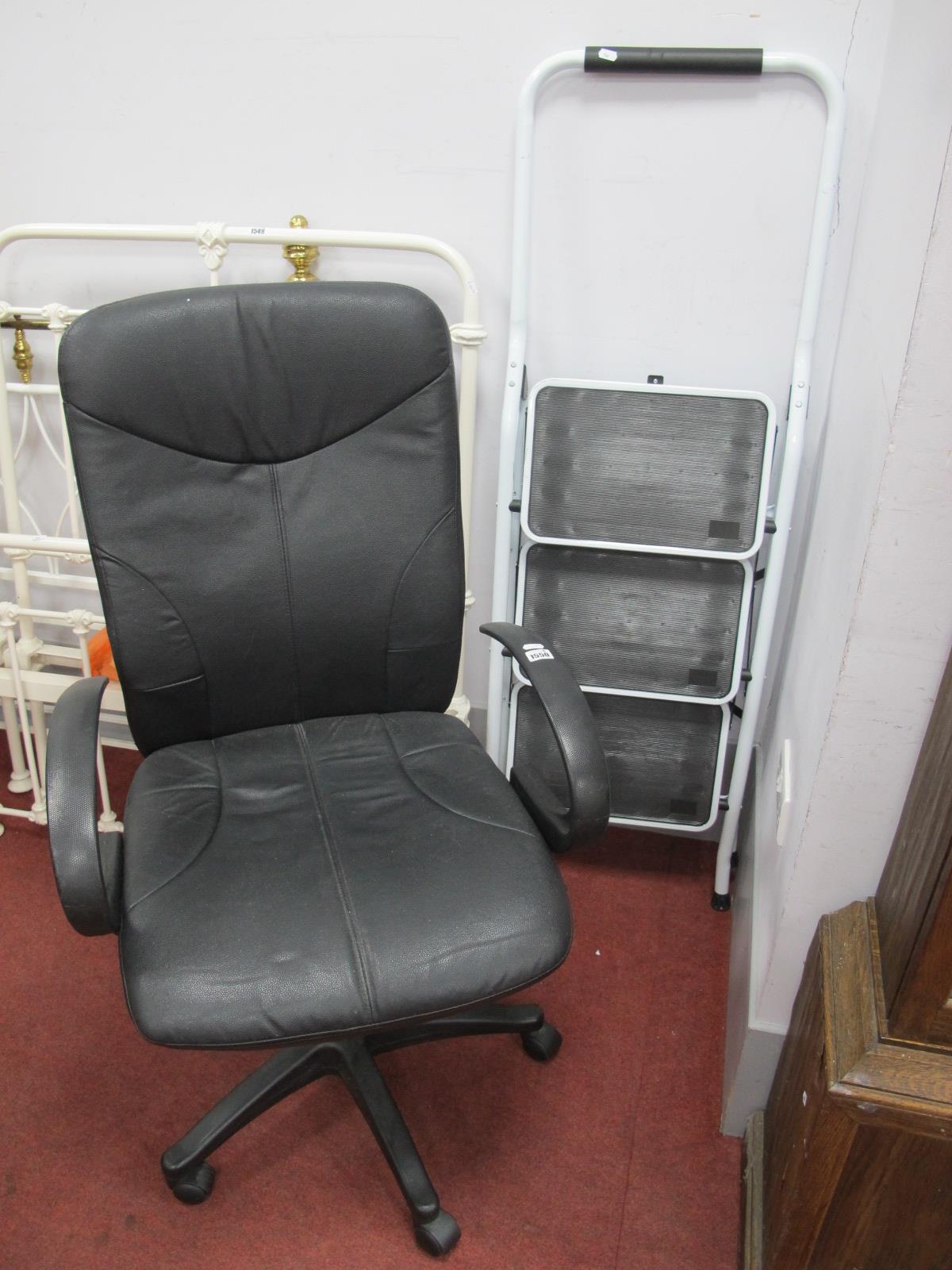 A Swivel Black Office Chair, on five star base. Folding steps.