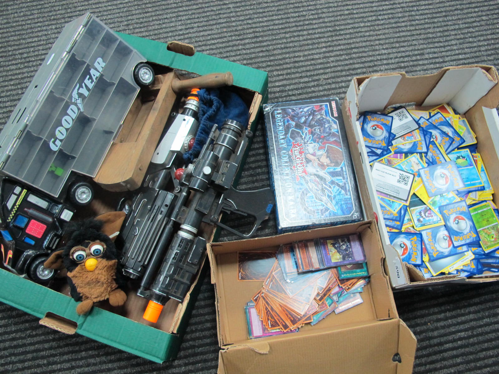 Pokemon Trade Cards, Star Wars Guns, marbles, wooden rattle, etc:- Two Boxes.