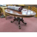 A XIX Century Centre Table, with oval mahogany tilt top, on carved four legged base, with turned