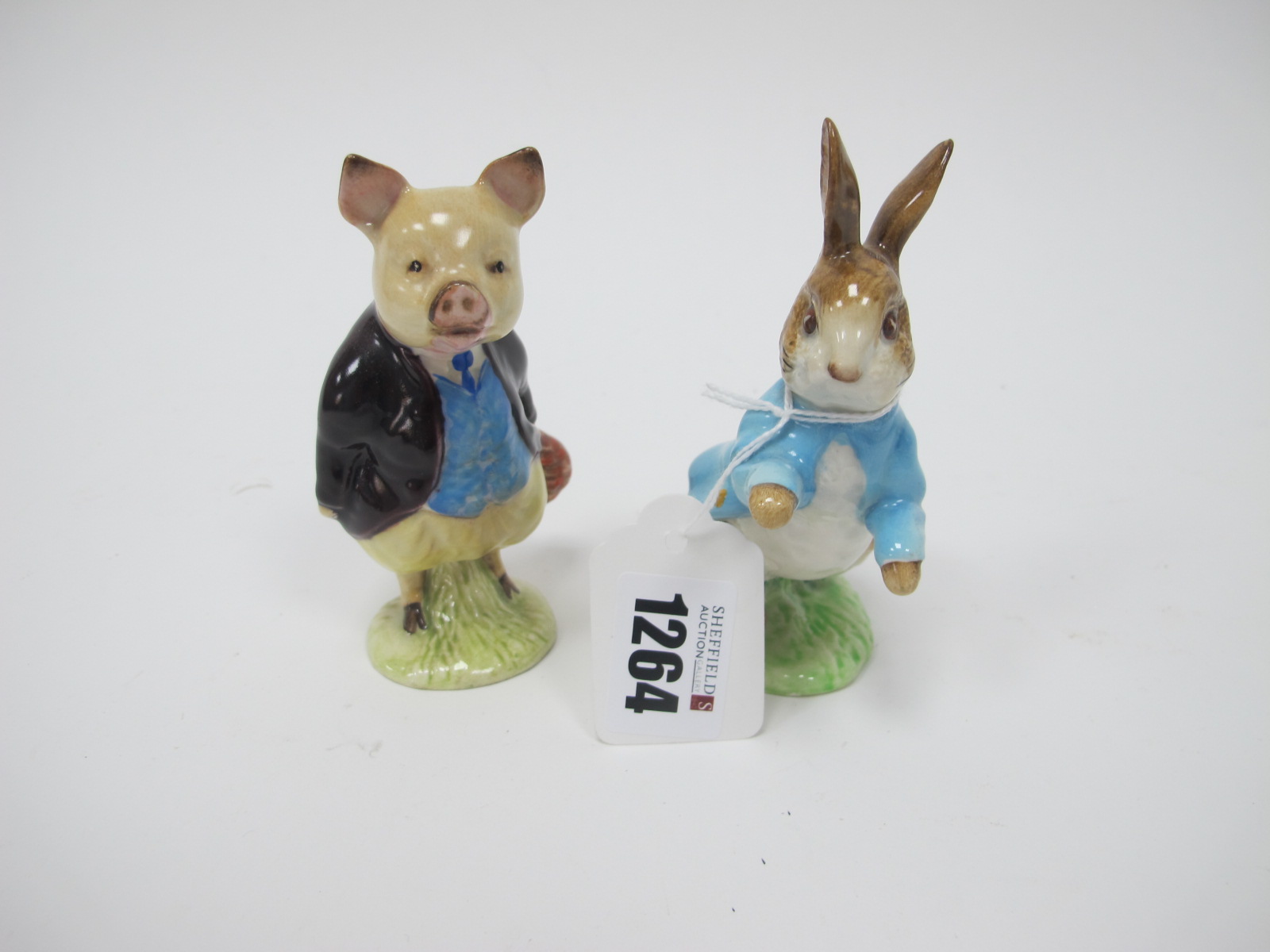Beswick Beatrix Potter Figures - Pigling Bland, in maroon coat, and Peter Rabbit both gold