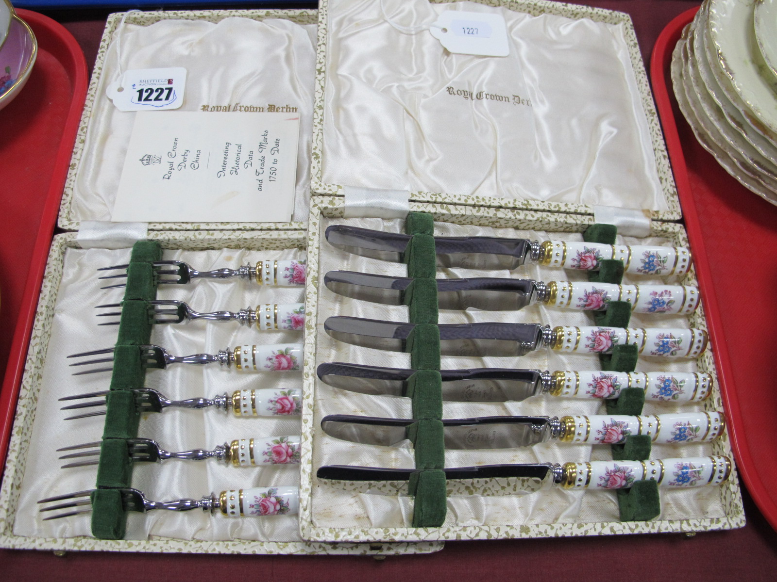 A Cased Set of Six Royal Crown Derby Dessert Knives, each with rose pattern handles together with