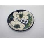 A Moorcroft Pottery Coaster, painted in the Snow Song design by Rachel Bishop, 12cm diameter.