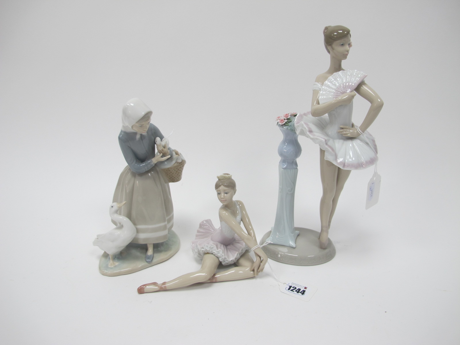 A Lladro Ballet Dancer 6371, 30cm high, seated ballerina, lady with goose. (3)