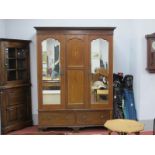 An Edwardian Mahogany Inlaid Two Door Wardrobe, with a stepped pediment, twin mirror doors, over two