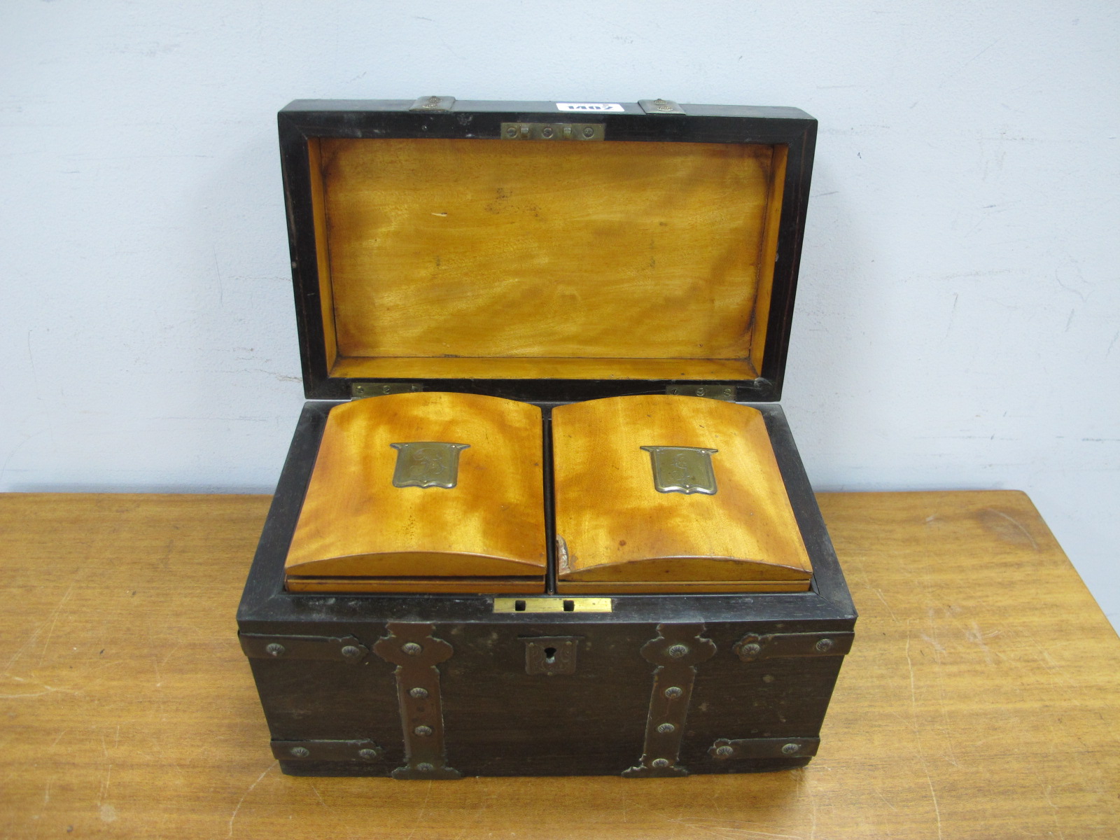 A XIX Coromandel Tea Caddy, with brass strap work 20cms wide, with satinwood caddies.