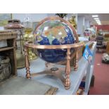 A Splendor Elegance Gem Stone Globe, set in a coppered stand, approximately 20cm diameter.