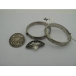 A Hallmarked Silver Hinged Bangle, together with another example, a decorative fan brooch and a