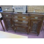 A Late XIX Century Oak Sideboard, with two centre bow fronted drawers, one to each end, over