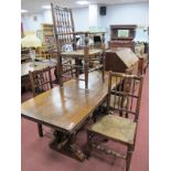 A XX Century Oak Refectory Table, the top with knulled decoration, on trestle bases with twin