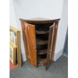 An XVIII Century Mahogany Bow Fronted Corner Cupboard, with three internal shelves, moulded bases,