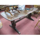 An Ercol Refectory Table, with shaped trestle ends, central stretcher. 177cm wide.