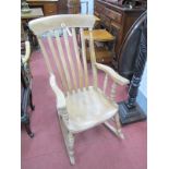 A XIX Century Ash-Elm Rocking Chair, with rail supports, shaped arms on turned legs, H stretcher, on