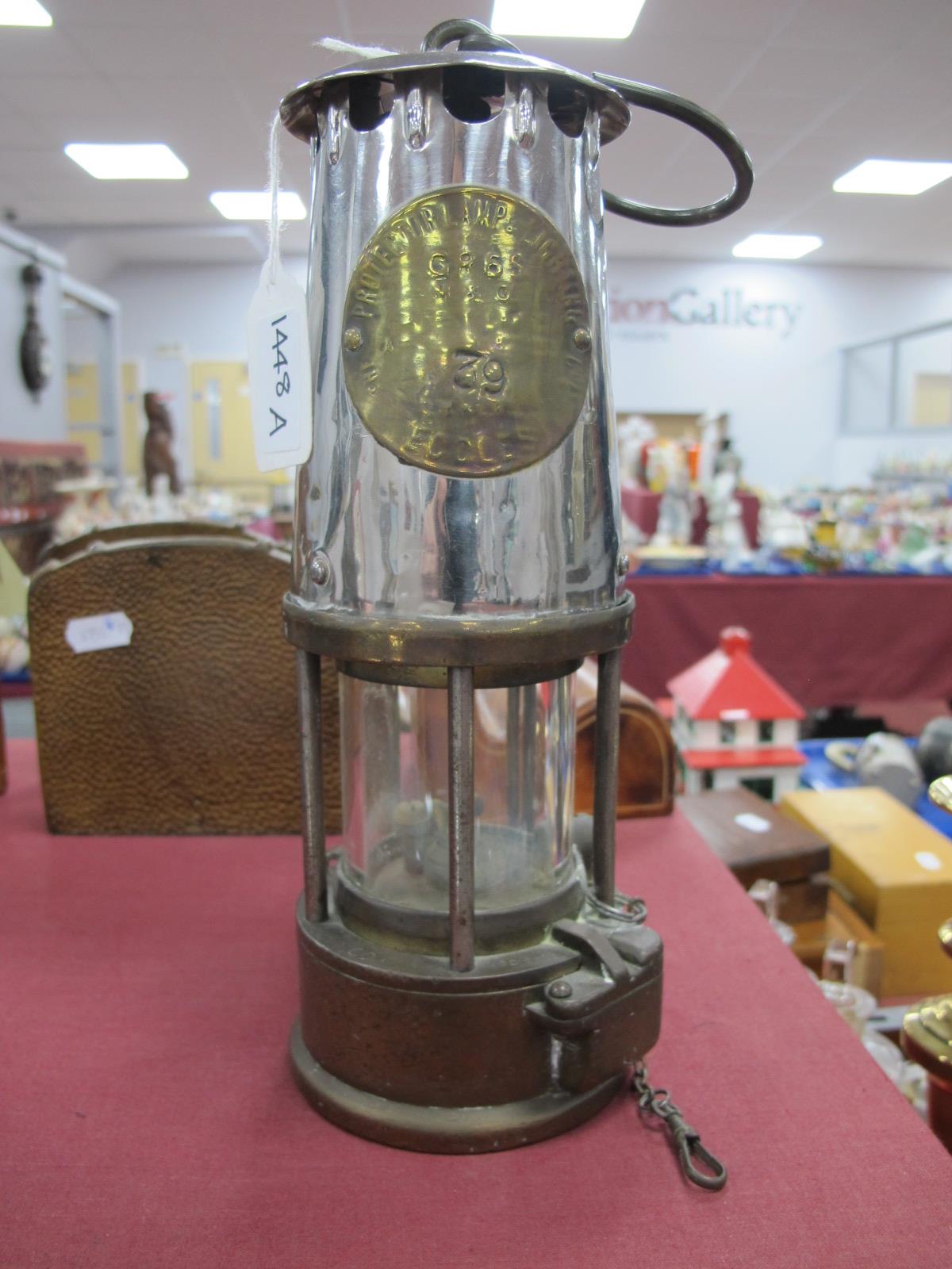 A Miners Lamp by Proctor Lamp and Lighting Co, 24.5cm high with handle down.