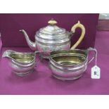 A Hallmarked Silver Three Piece Tea Service, of oval bulbous form, elaborately engraved with bands