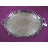 Am Electroplated Oval Twin Handled Tray, of foliate design, with openwork bead edge, on bun feet.