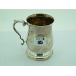 A Hallmarked Silver Tankard, of bulbous form, with stepped circular base, handle with leaf moulding,