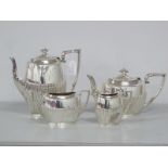 A Hallmarked Silver Four Piece Tea and Coffee Service, of oval form, the lower sections and lids