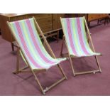 A Pair of "Spinney" Deck Chairs, with green, pink and grey striped canvas seats.