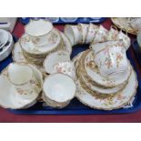 An Early XX Century China Tea Service, decorated with flowers and highlighted in gilt, forty