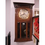 A XX Century Wall Clock, with a silvered dial, Arabic numerals, glazed door.