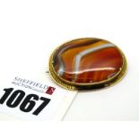A c.XIX Century Banded Agate Panel Brooch, oval collet set.