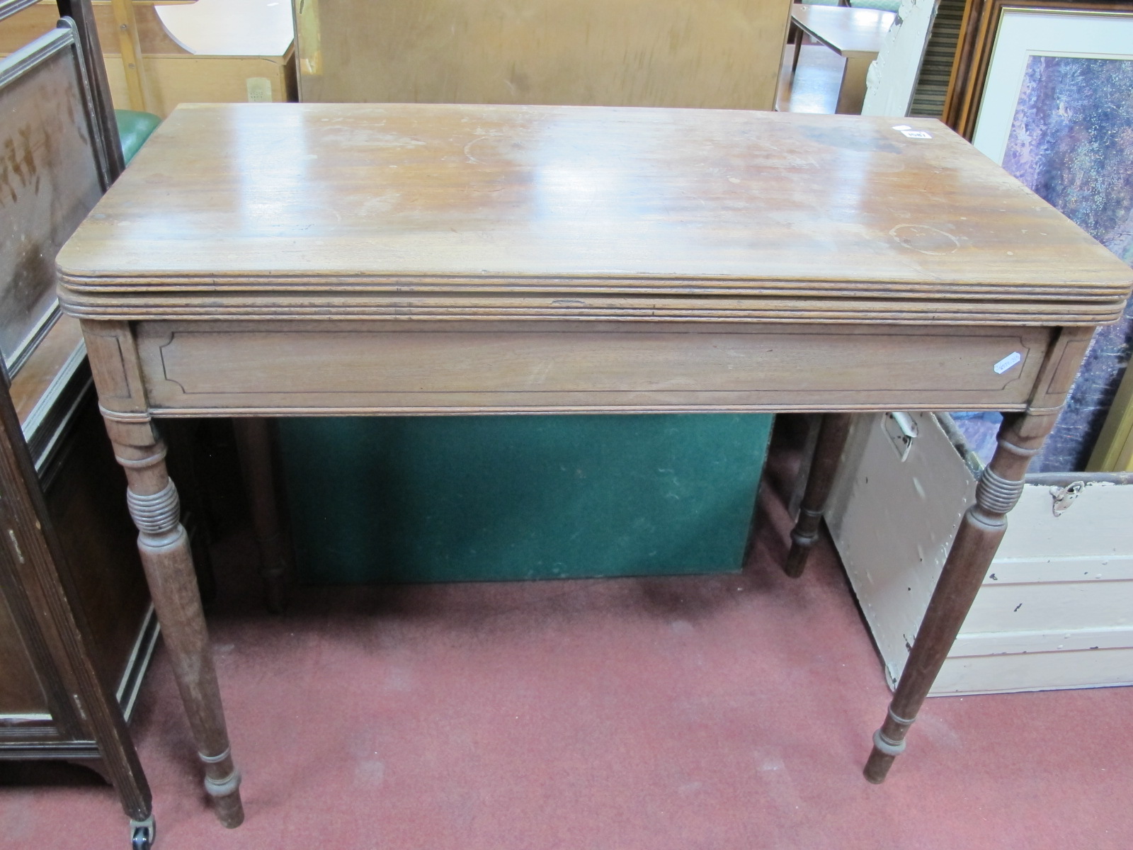 An Early XIX Century Mahogany Tea Table, with a fold over top, on turned supports, together with a