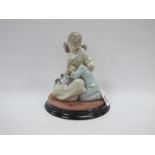 A Lladro Figurine Group of Two Sisters, with a cat laying on a knee of one of the girls, on ebonised