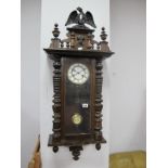 A XIX Century Walnut Cased Viennese Wall Clock, eight day movement, eagle finial and mask support.