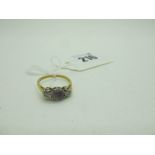 A Three Stone Ring, claw and illusion set, stamped "18ct Plat" (finger size O).