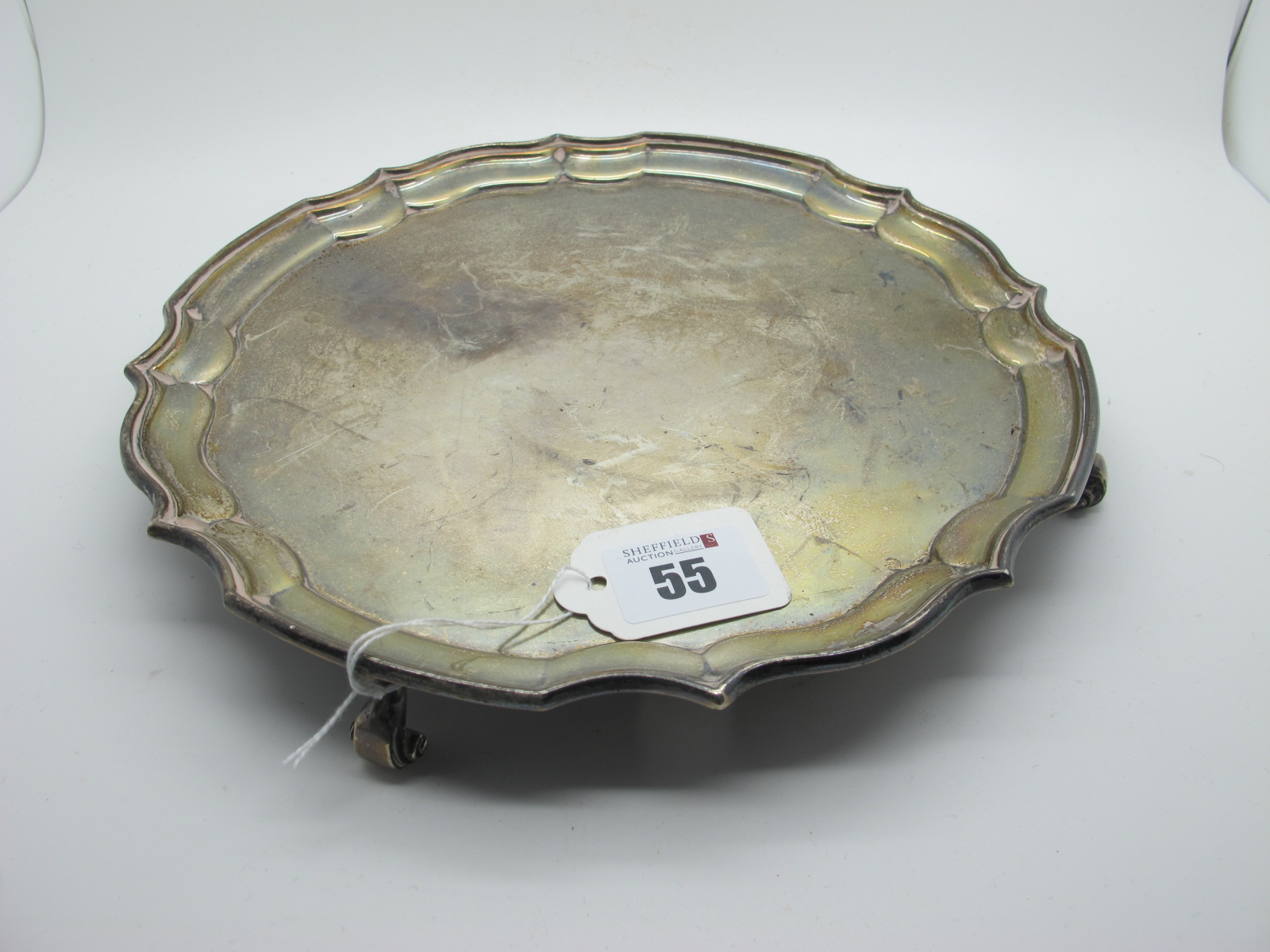 A Hallmarked Silver Salver, JD&S, Sheffield 1935, of shaped circular form, raised on four scroll