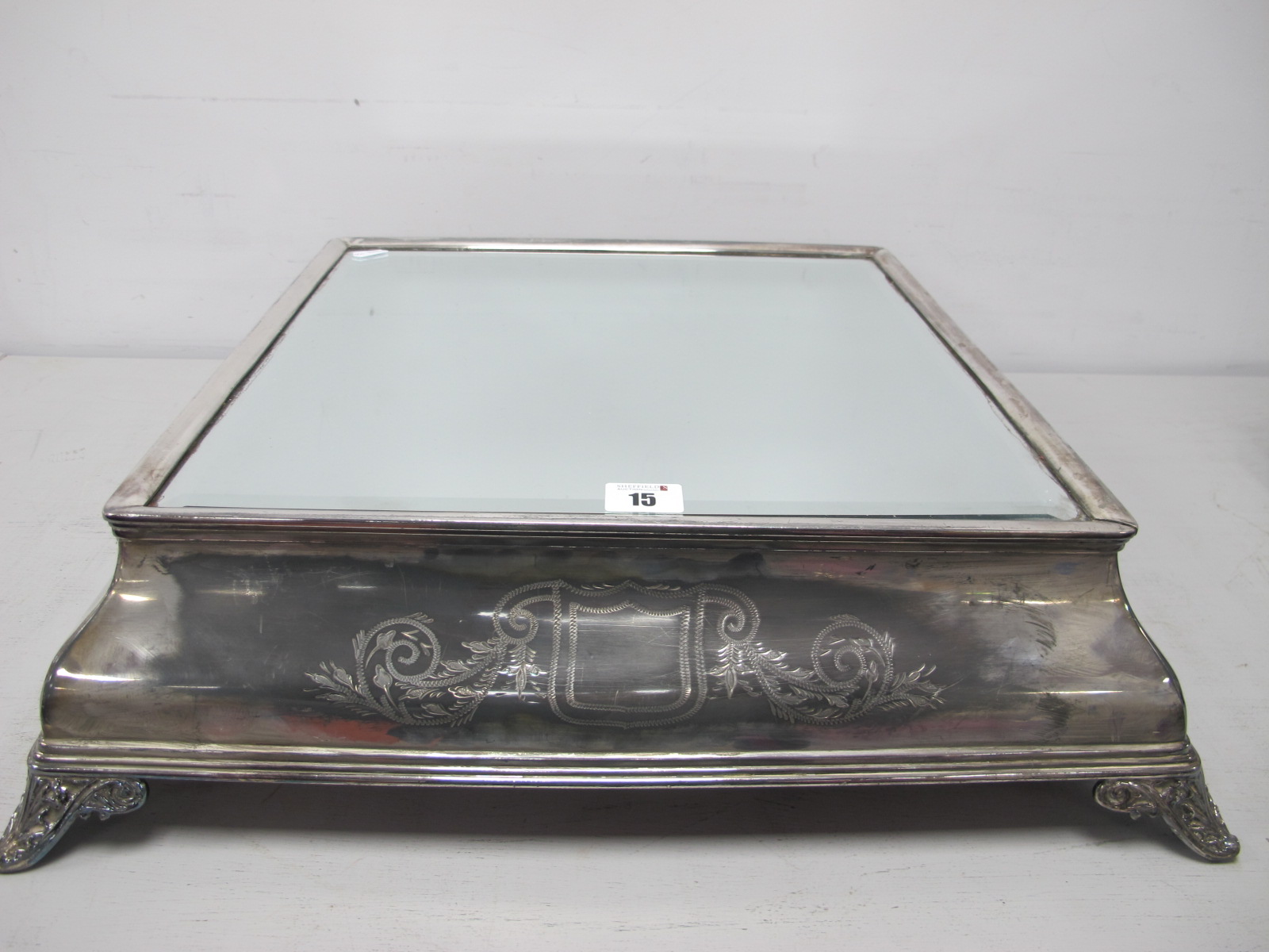 A Square Plated Mirror Plateau / Wedding Cake Stand, detailed with vacant shields and scrolls, on