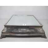 A Square Plated Mirror Plateau / Wedding Cake Stand, detailed with vacant shields and scrolls, on