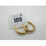 A Pair of Modern Hoop Earrings, of textured finish, stamped "375" (2.8grams).