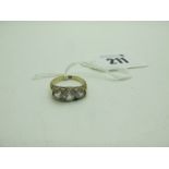 A Three Stone Dress Ring, within scroll carved setting, stamped "18" (finger size K) (4grams).