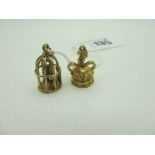 A 9ct Gold Crown Charm Pendant, together with a 9ct gold novelty bird cage charm pendant (total