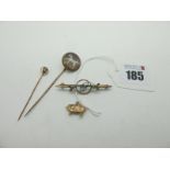 A Late XIX / Early XX Century Stickpin, the circular glazed finial detailed with hand painted dog,