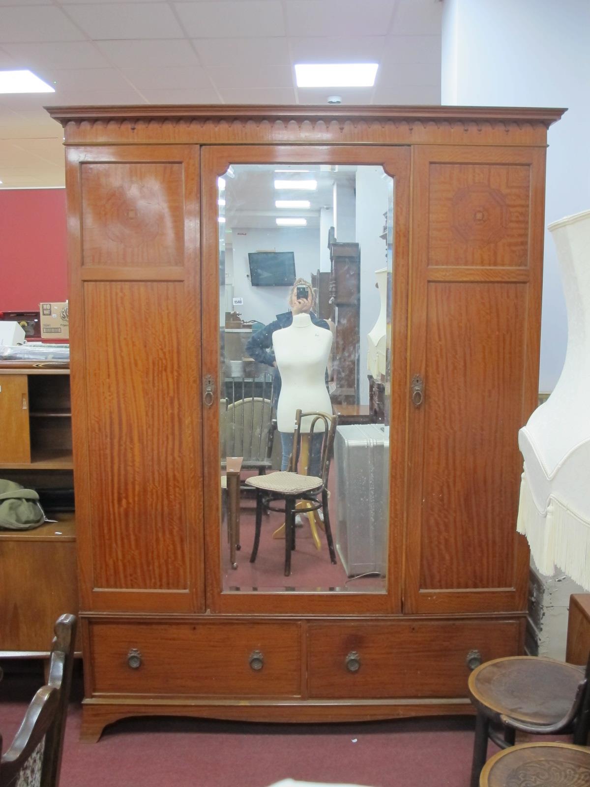 An Early XX Century Satinwood Triple Wardrobe, with stepped pediment, central mirror door flanked by